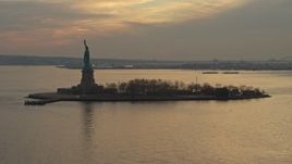 5K aerial stock footage of flying by the Statue of Liberty in New York, winter, sunset Aerial Stock Footage | AX0065_0183E