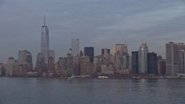5K aerial stock footage approach the Lower Manhattan and WTC skyline from New York Harbor, New York City, winter, sunset Aerial Stock Footage | AX0065_0189E