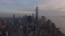5K aerial stock footage of One World Trade Center towering over Lower Manhattan skyscrapers, New York City, winter, sunset Aerial Stock Footage | AX0065_0197E