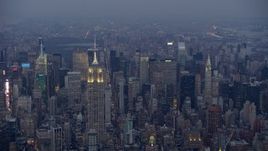 5K aerial stock footage approach top of Empire State Building in Midtown Manhattan, New York City, winter, twilight Aerial Stock Footage | AX0065_0234
