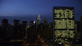 5K aerial stock footage of a view of the Chrysler Building, flyby the United Nations, Midtown Manhattan, New York City, winter, night Aerial Stock Footage | AX0065_0273