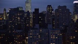 5K aerial stock footage flyby busy streets between rows of skyscrapers in Midtown Manhattan, New York City, winter, night Aerial Stock Footage | AX0065_0275E