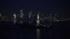 5K aerial stock footage flyby Statue of Liberty to approach the skyline of Lower Manhattan, New York City, winter, night Aerial Stock Footage | AX0065_0285E