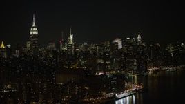 5K aerial stock footage of riverfront power plant, Empire State Building, and Midtown Manhattan skyline, New York City, winter, night Aerial Stock Footage | AX0065_0303