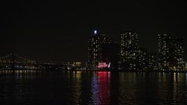 5K aerial stock footage low approach to the Pepsi Sign and waterfront apartment buildings in Queens, New York City, winter, night Aerial Stock Footage | AX0065_0307E