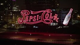 5K aerial stock footage fly low to approach and flyby the Pepsi Sign and riverfront apartment buildings in Queens, New York City, winter, night Aerial Stock Footage | AX0065_0310E
