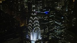 5K aerial stock footage tilt from the top of the Chrysler Building to reveal Empire State Building and Midtown Manhattan, New York City, winter, night Aerial Stock Footage | AX0065_0319E