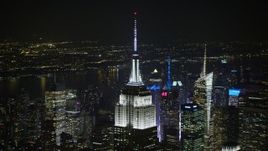 5K aerial stock footage orbit the Empire State Building in Midtown Manhattan, New York City, winter, night Aerial Stock Footage | AX0065_0323E
