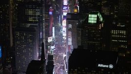 5K aerial stock footage of skyscrapers, bright screens and tourist crowds at Times Square in Midtown Manhattan, New York City, winter, night Aerial Stock Footage | AX0065_0351E