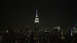 5K aerial stock footage of the Empire State Building and Midtown Manhattan skyscrapers, New York City, winter, night Aerial Stock Footage | AX0065_0365