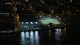 5K aerial stock footage track a helicopter flying by the Midtown Manhattan riverfront, New York City, winter, night Aerial Stock Footage | AX0065_0366