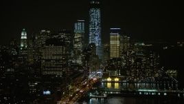 5K aerial stock footage approach West Street and piers in Greenwich Village, skyscrapers in Lower Manhattan, New York City, winter, night Aerial Stock Footage | AX0065_0373E