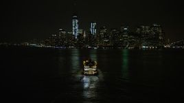 5K aerial stock footage track Staten Island Ferry sailing New York Harbor, reveal Lower Manhattan skyline, New York City, winter, night Aerial Stock Footage | AX0065_0386E