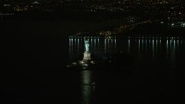 5K aerial stock footage of Statue of Liberty monument on Liberty Island in New York, winter, night Aerial Stock Footage | AX0065_0388E