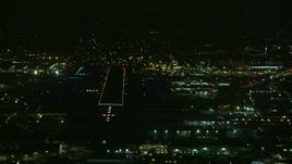 7.6K aerial stock footage of the runways at Burbank Airport lit up for the night, California Aerial Stock Footage | AX0156_003