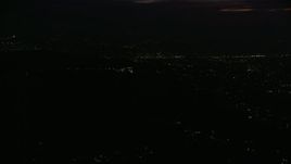 7.6K aerial stock footage of a view of the Griffith Observatory in the hills at night in Los Angeles, California Aerial Stock Footage | AX0156_007