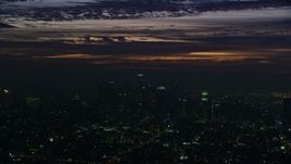 7.6K aerial stock footage of clouds above Downtown Los Angeles skyscrapers at sunrise, California Aerial Stock Footage | AX0156_024E