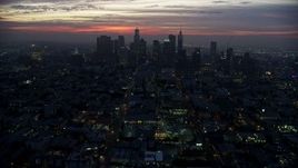 7.6K aerial stock footage tilting from MacArthur Park to reveal Downtown Los Angeles skyline at sunrise, California Aerial Stock Footage | AX0156_043E