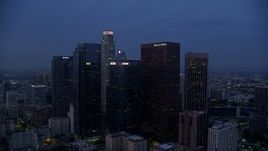 7.6K aerial stock footage passing by towering skyscrapers in Downtown Los Angeles at sunrise, California Aerial Stock Footage | AX0156_053E