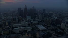 7.6K aerial stock footage flying by City Hall with a view of skyscrapers in Downtown Los Angeles, California, early in the morning Aerial Stock Footage | AX0156_077E