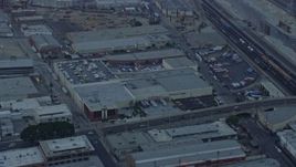 7.6K aerial stock footage of warehouse building by the Fourth Street Viaduct in Boyle Heights, Los Angeles, California at sunrise Aerial Stock Footage | AX0156_101