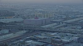 7.6K aerial stock footage of office building and heavy traffic on I-10 in Downtown Los Angeles, California at sunrise Aerial Stock Footage | AX0156_104