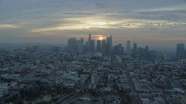 7.6K aerial stock footage flying over Koreatown office buildings to approach the skyline of Downtown Los Angeles, California at sunrise Aerial Stock Footage | AX0156_110E