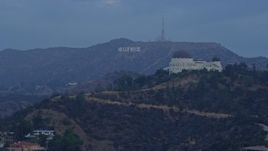 7.6K aerial stock footage of a view of the Hollywood Sign seen while passing Griffith Observatory at sunrise in Los Angeles, California Aerial Stock Footage | AX0156_118