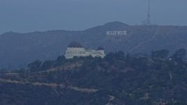 7.6K aerial stock footage approaching Griffith Observatory with the Hollywood Sign in the background at sunrise, Los Angeles, California Aerial Stock Footage | AX0156_119