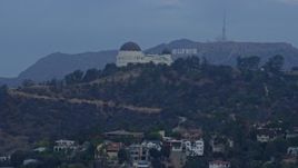 7.6K aerial stock footage flying by Griffith Observatory to reveal the Hollywood Sign at sunrise, Los Angeles, California Aerial Stock Footage | AX0156_120