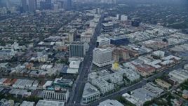7.6K aerial stock footage flying over Wilshire Boulevard towards Santa Monica Blvd, near Century City, sunrise, Beverly Hills, California Aerial Stock Footage | AX0156_130