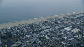 7.6K aerial stock footage passing homes by the beach at sunrise, Venice, California Aerial Stock Footage | AX0156_154