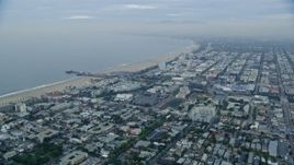 7.6K aerial stock footage flying over Santa Monica neighborhoods to approach Santa Monica Pier at sunrise, California Aerial Stock Footage | AX0156_155E