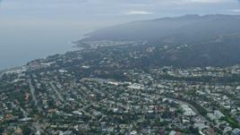 7.6K aerial stock footage flying over Palisades Charter High School and coastal neighborhoods at sunrise, Pacific Palisades, California Aerial Stock Footage | AX0156_161E