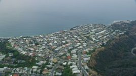 7.6K aerial stock footage flying by and orbiting homes overlooking the ocean in the morning in Pacific Palisades, California Aerial Stock Footage | AX0156_163E