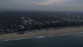 7.6K aerial stock footage of light traffic on Pacific Coast Highway on the edge of Pacific Palisades / Santa Monica at sunrise, California Aerial Stock Footage | AX0156_167E