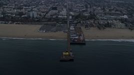 7.6K aerial stock footage of Santa Monica Pier, seen from the ocean at sunrise, Santa Monica, California Aerial Stock Footage | AX0156_169E