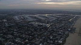 7.6K aerial stock footage flying over Venice neighborhoods to approach and flyby Marina Del Rey harbor at sunrise, California Aerial Stock Footage | AX0156_172E