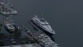 7.6K aerial stock footage of a mega yacht docked in harbor with helicopter on back, sunrise, Marina Del Rey, California Aerial Stock Footage | AX0156_176