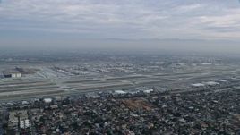 7.6K aerial stock footage of a sideview of LAX on a cloudy morning, sunrise, Los Angeles, California Aerial Stock Footage | AX0156_189