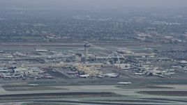 7.6K aerial stock footage of LAX and its control tower on a cloudy morning, sunrise, Los Angeles, California Aerial Stock Footage | AX0156_190