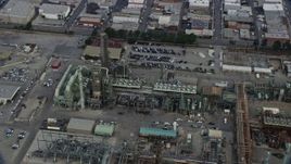 7.6K aerial stock footage flying by an oil refinery structures in the morning in El Segundo, California Aerial Stock Footage | AX0156_197
