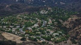 7.6K aerial stock footage flying by homes on a hill in Topanga, California Aerial Stock Footage | AX0157_022