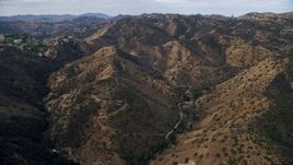7.6K aerial stock footage flying over brown hills and trees, Canoga park, California Aerial Stock Footage | AX0157_038E