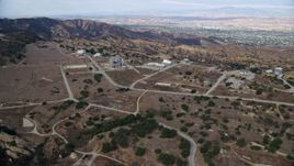 7.6K aerial stock footage approaching roads and buildings of the Rocektdyne aerospace testing facility, Brandeis, California Aerial Stock Footage | AX0157_047
