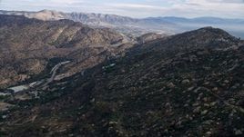 7.6K aerial stock footage flying over Simi Valley hills towards San Fernando Valley, California Aerial Stock Footage | AX0157_053E