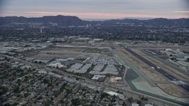 7.6K aerial stock footage dying by Burbank airport at twilight, Burbank, California Aerial Stock Footage | AX0158_001