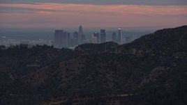 7.6K aerial stock footage reveal of Downtown Los Angeles from behind a hill, twilight, California Aerial Stock Footage | AX0158_004E