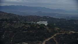 7.6K aerial stock footage orbiting Griffith Observatory from behind to reveal skyline and city sprawl, twilight, Los Angeles, California Aerial Stock Footage | AX0158_011E