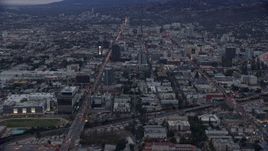 7.6K aerial stock footage approaching Sunset Boulevard and neighboring businesses, twilight, Hollywood, California Aerial Stock Footage | AX0158_015